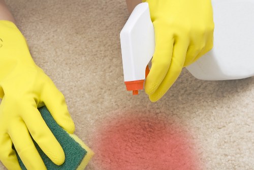 Cleaner in Battersea carrying out a safe cleaning task with protective measures