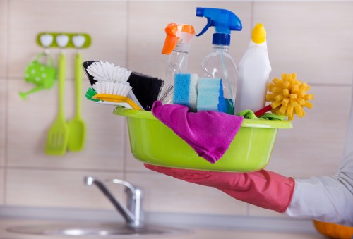 Cleaner using safe manual handling techniques with equipment